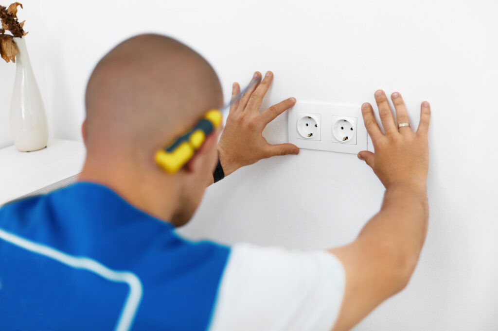 Electrician Installing Wall Socket at Rowbel Services